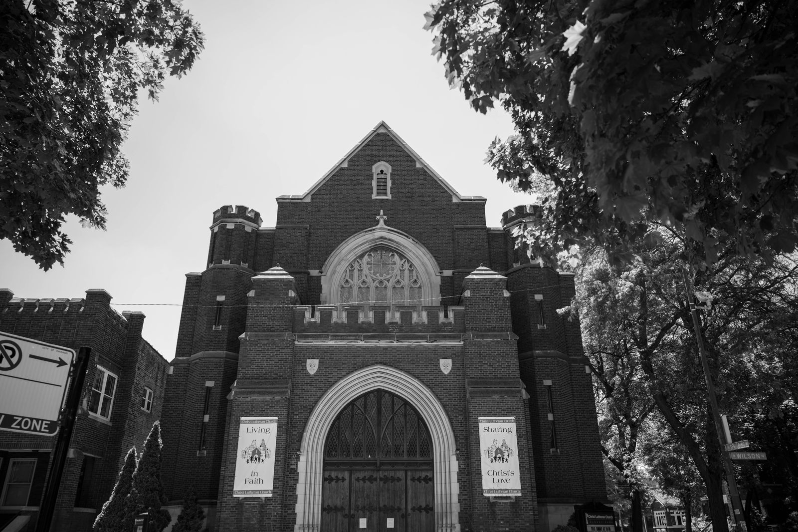 A black limousine parked outside a church before a service