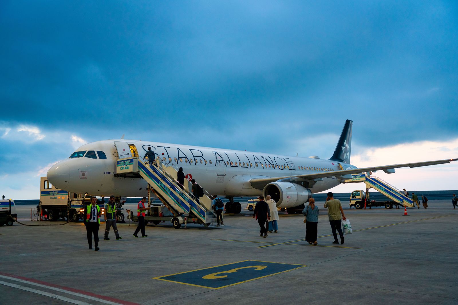 Passengers leaving a business jet with luggage ready for the car