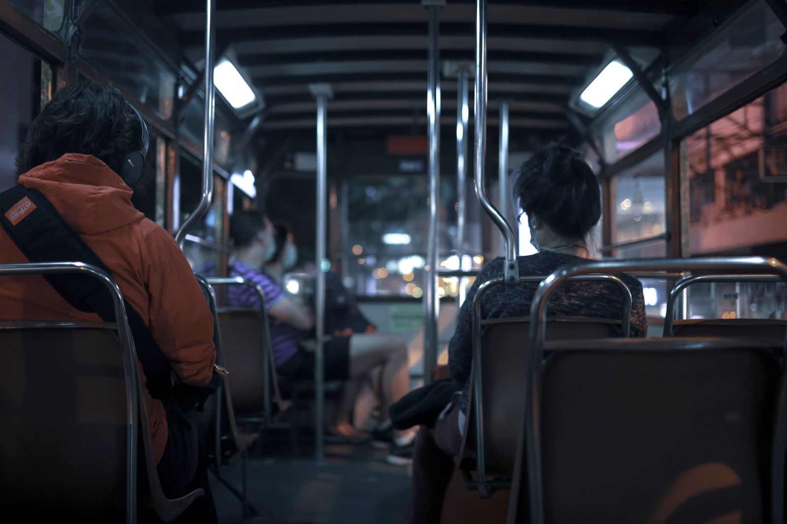 A bus travelling along a lit highway at night