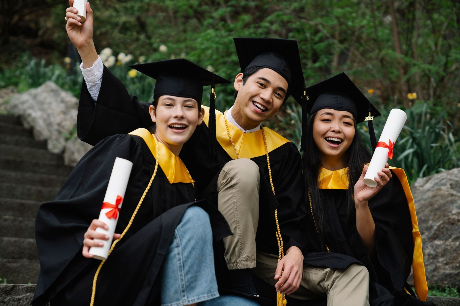 Graduates celebrating together in caps and gowns