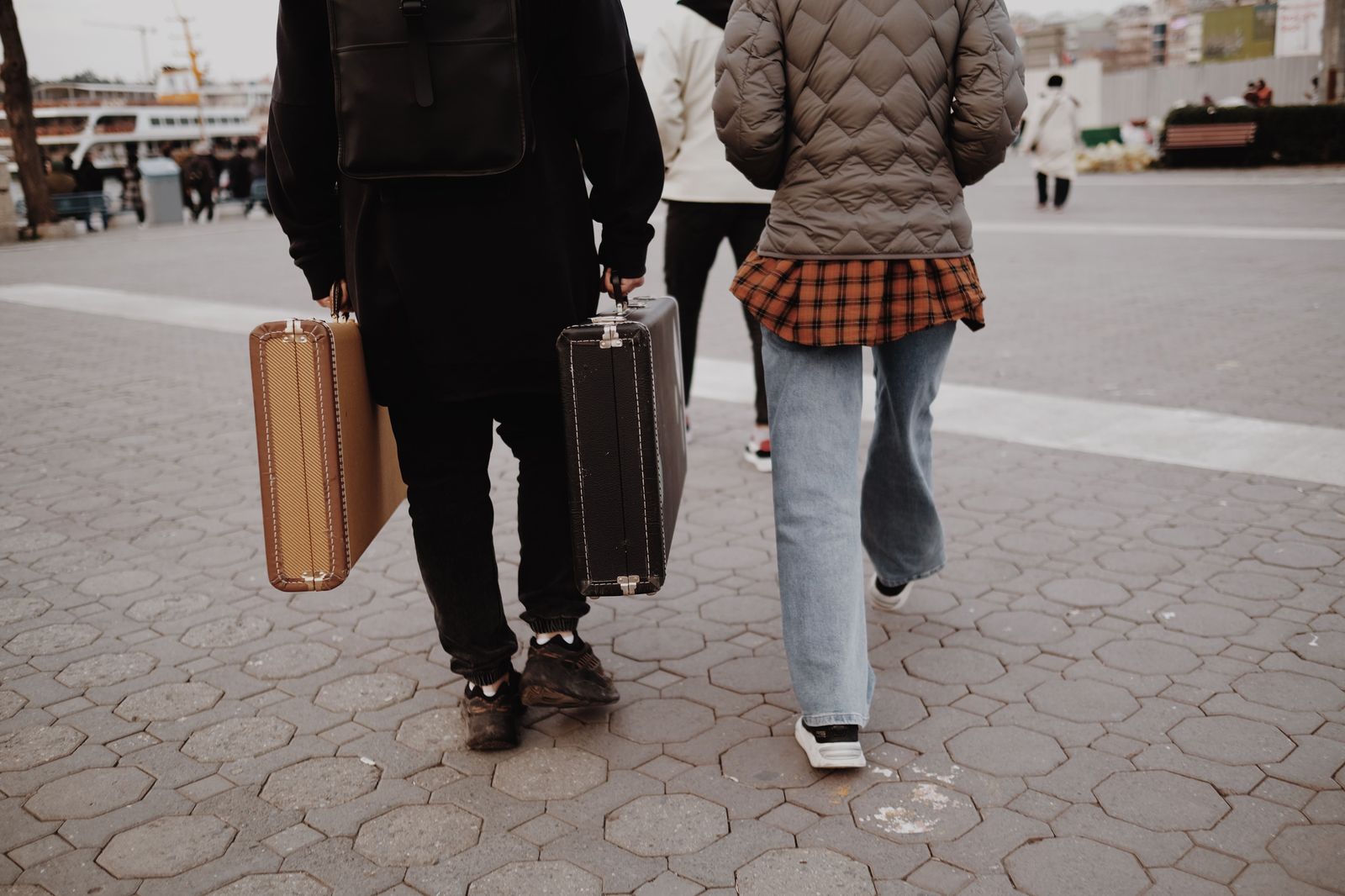 Group of travellers with suitcases waiting to board a private van